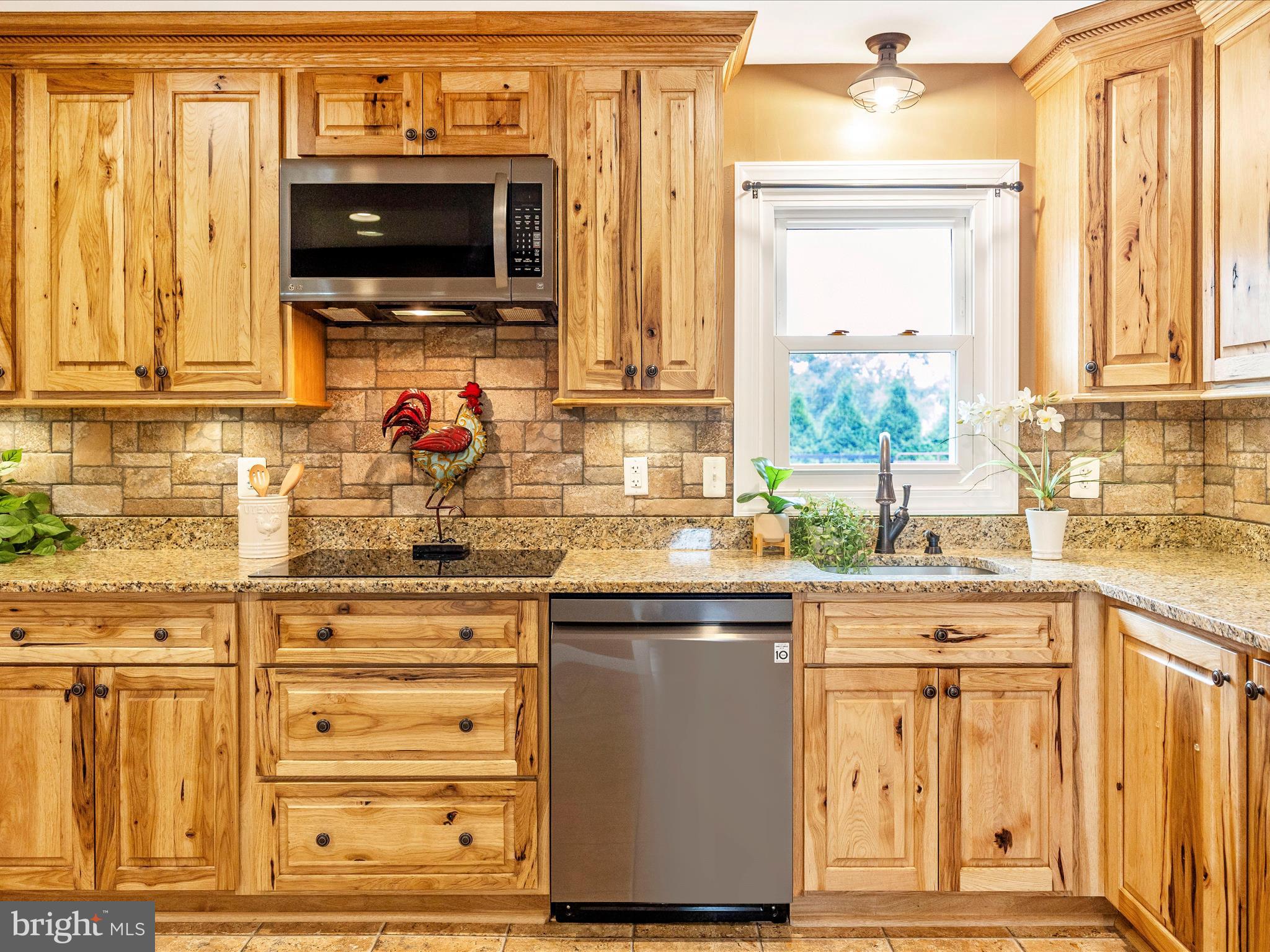 8429 Woodville Road Mount Airy, MD 21771 - Photo 13 of 75 a kitchen with stainless steel appliances granite countertop a stove and a microwave