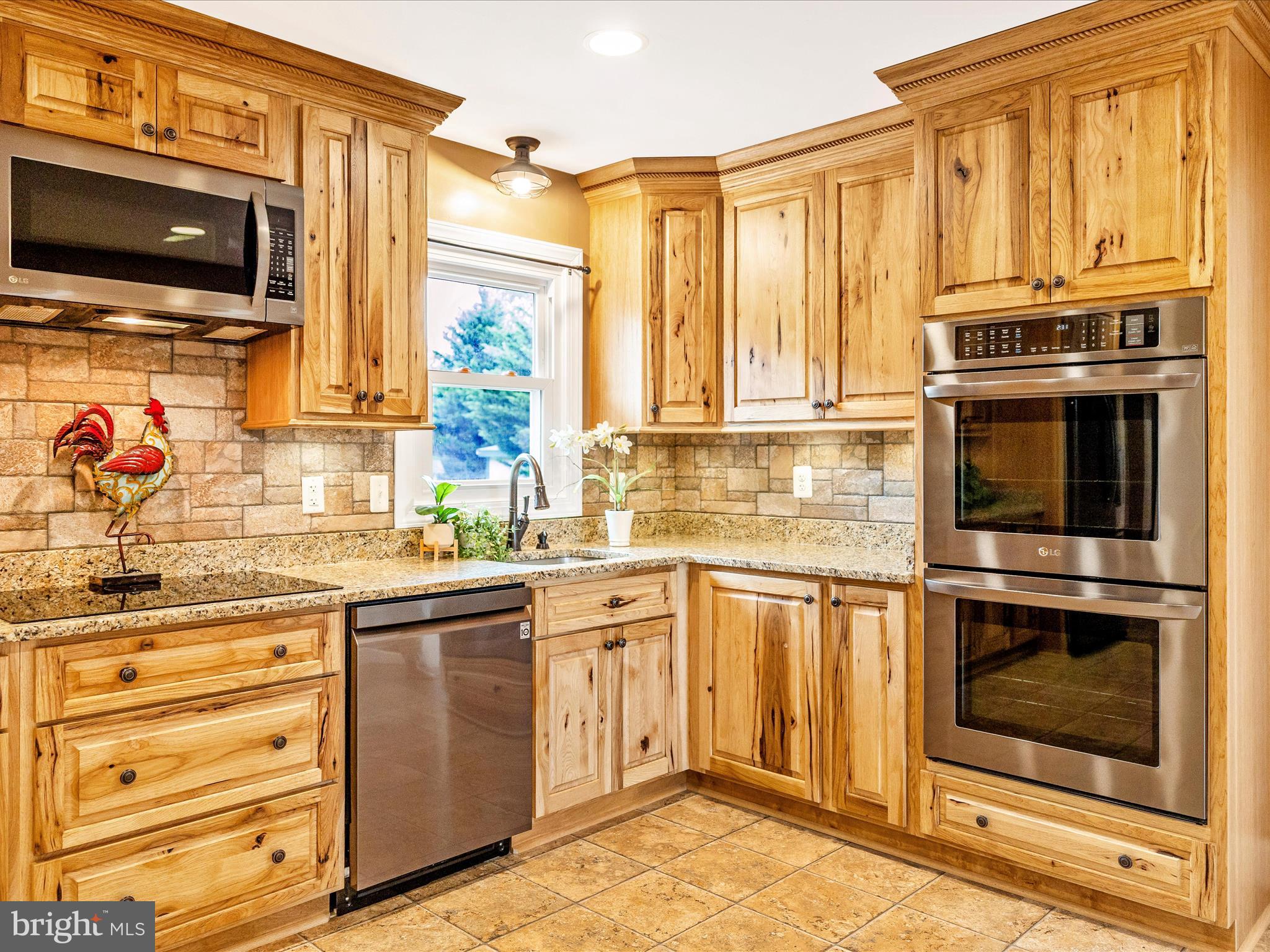 8429 Woodville Road Mount Airy, MD 21771 - Photo 14 of 75 a kitchen with stainless steel appliances granite countertop a stove microwave and cabinets