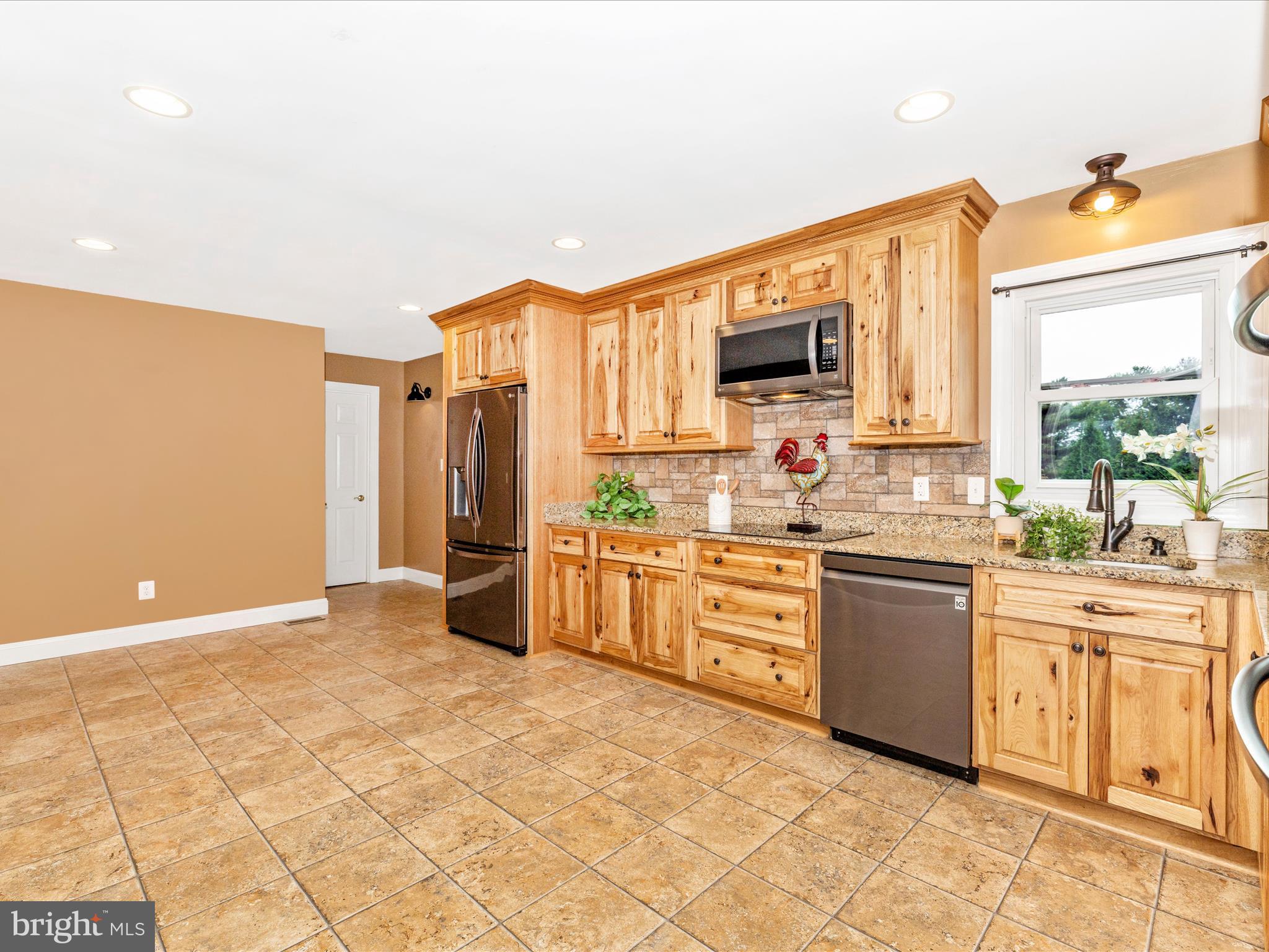 8429 Woodville Road Mount Airy, MD 21771 - Photo 18 of 75 a large kitchen with stainless steel appliances a stove a sink and a refrigerator