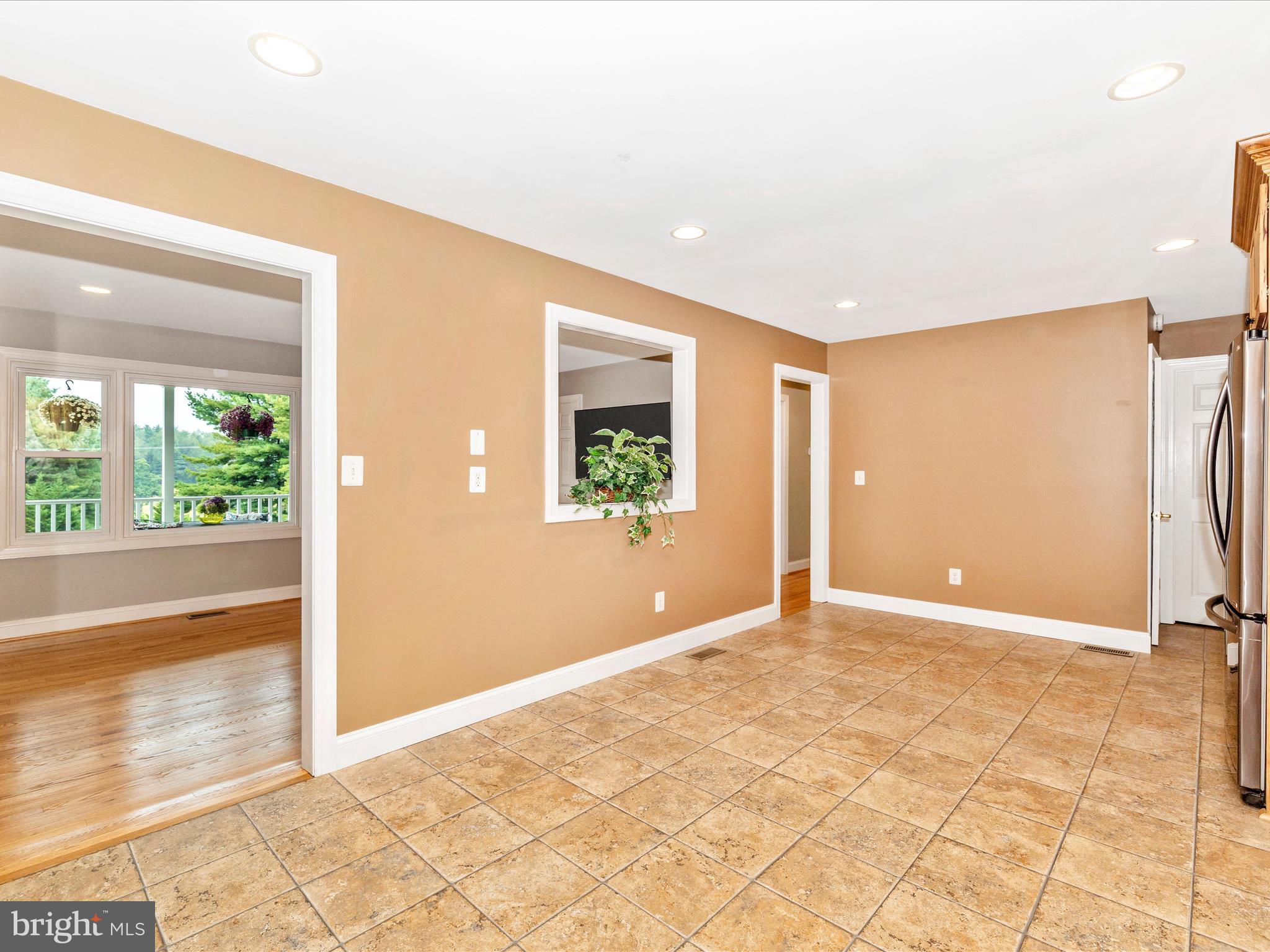8429 Woodville Road Mount Airy, MD 21771 - Photo 19 of 75 a view of an empty room with wooden floor and a window