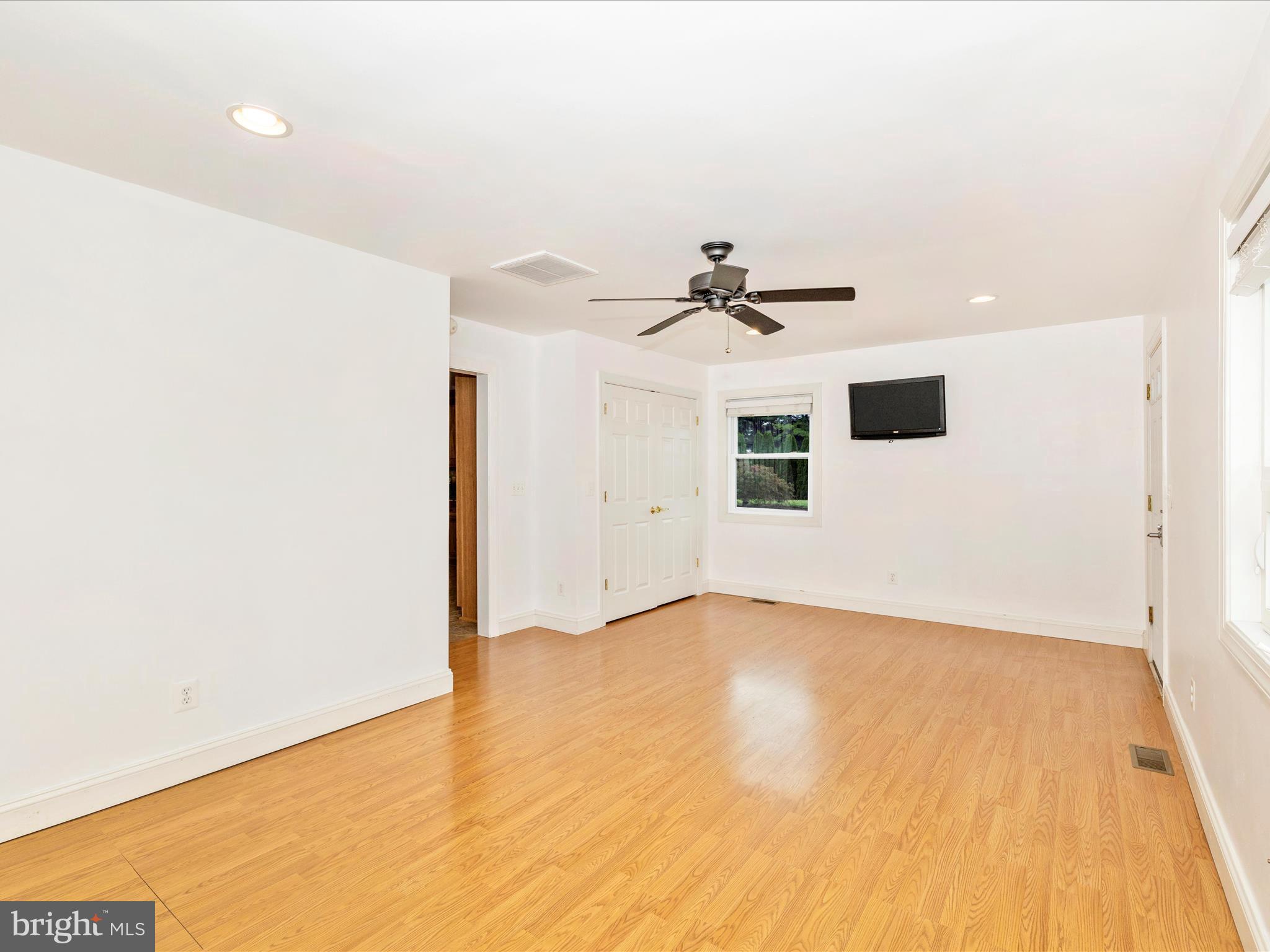 8429 Woodville Road Mount Airy, MD 21771 - Photo 23 of 75 a view of a livingroom with a ceiling fan and wooden floor