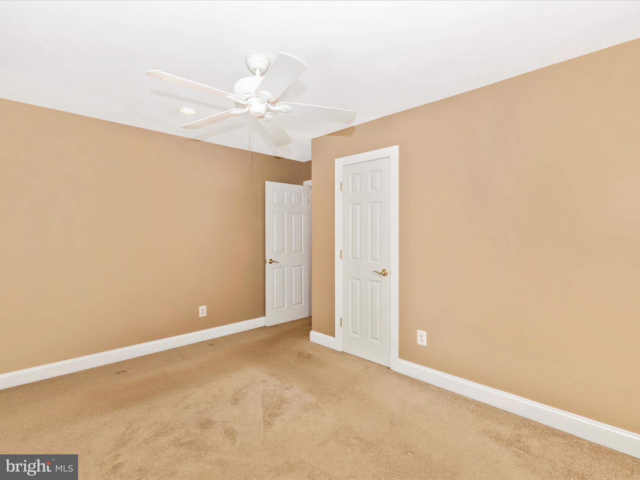 8429 Woodville Road Mount Airy, MD 21771 - Photo 26 of 75 an empty room with a ceiling fan and a window