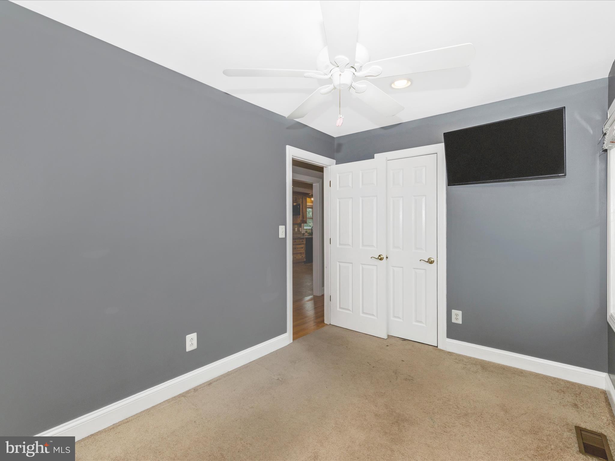 8429 Woodville Road Mount Airy, MD 21771 - Photo 30 of 75 a view of an empty room with a ceiling fan