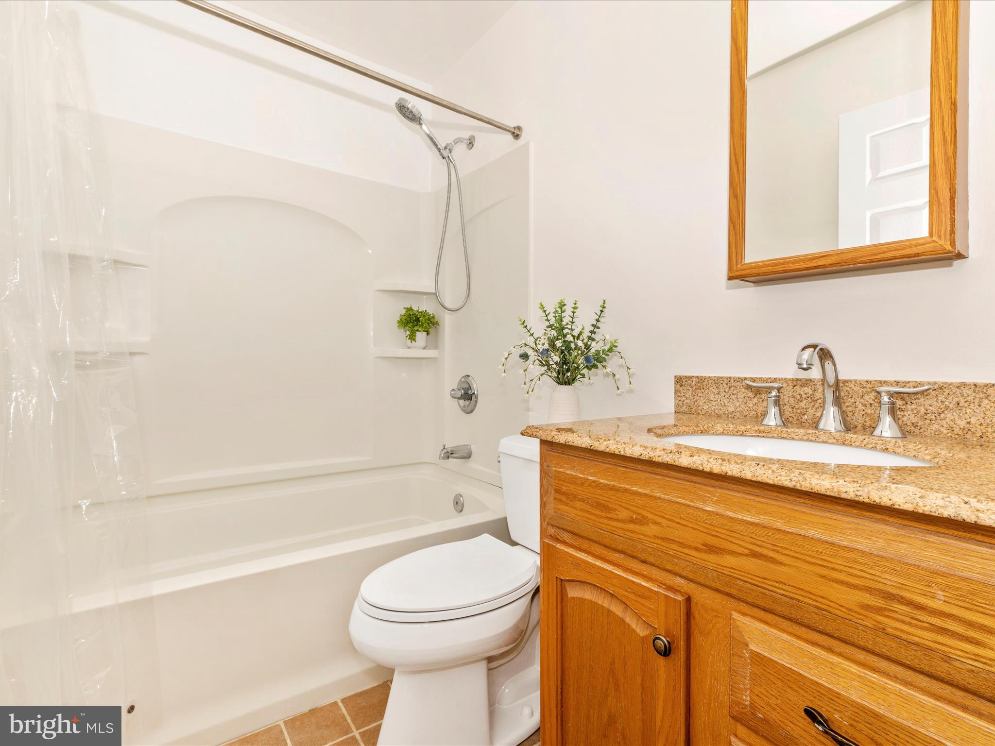 8429 Woodville Road Mount Airy, MD 21771 - Photo 31 of 75 a bathroom with a sink a toilet and shower