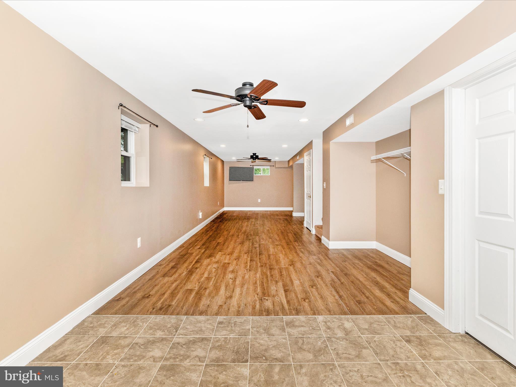 8429 Woodville Road Mount Airy, MD 21771 - Photo 38 of 75 a view of a big room with wooden floor and a ceiling fan