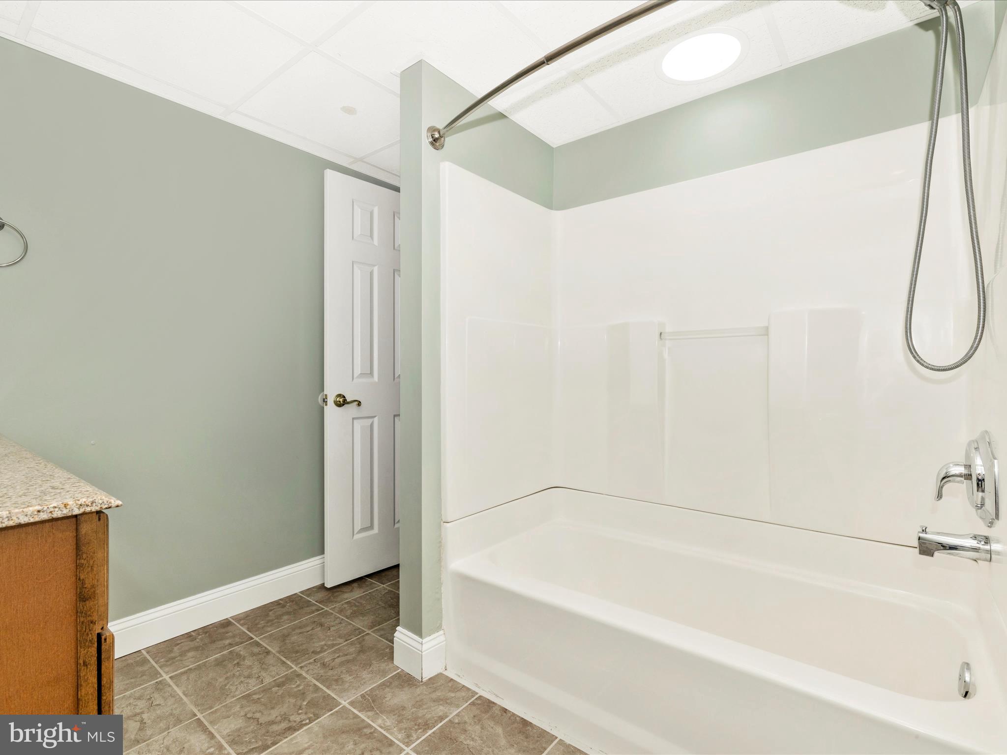 8429 Woodville Road Mount Airy, MD 21771 - Photo 41 of 75 a bathroom with a bathtub and a shower