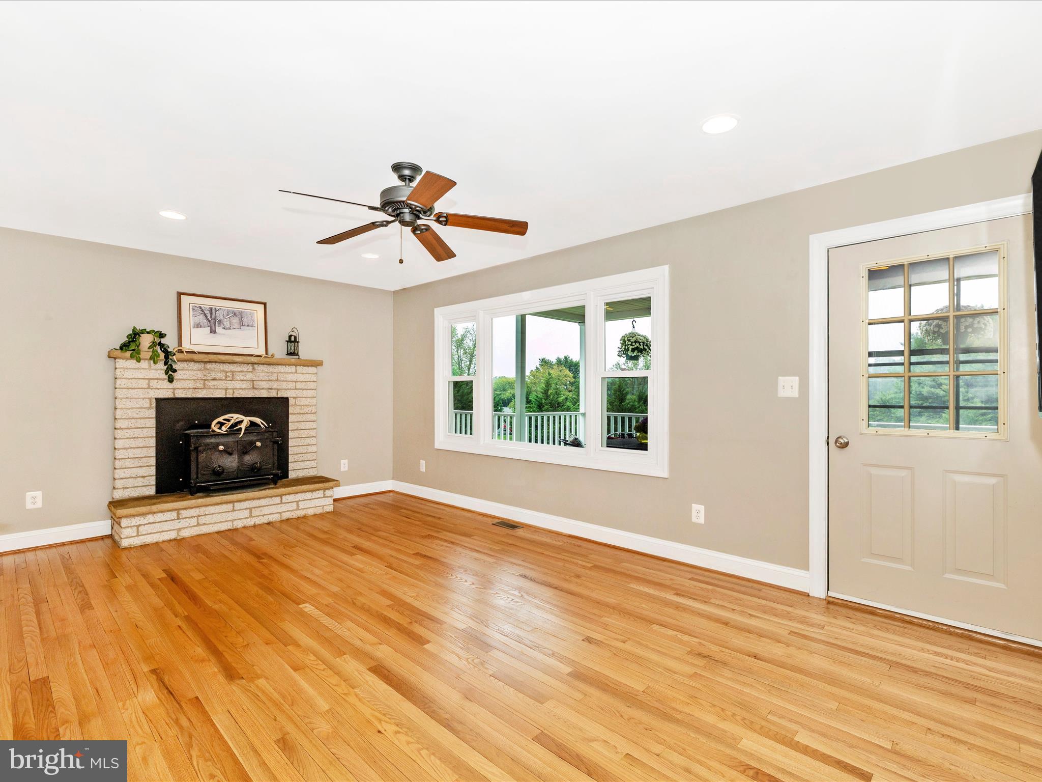 8429 Woodville Road Mount Airy, MD 21771 - Photo 8 of 75 a view of empty room with fireplace and wooden floor