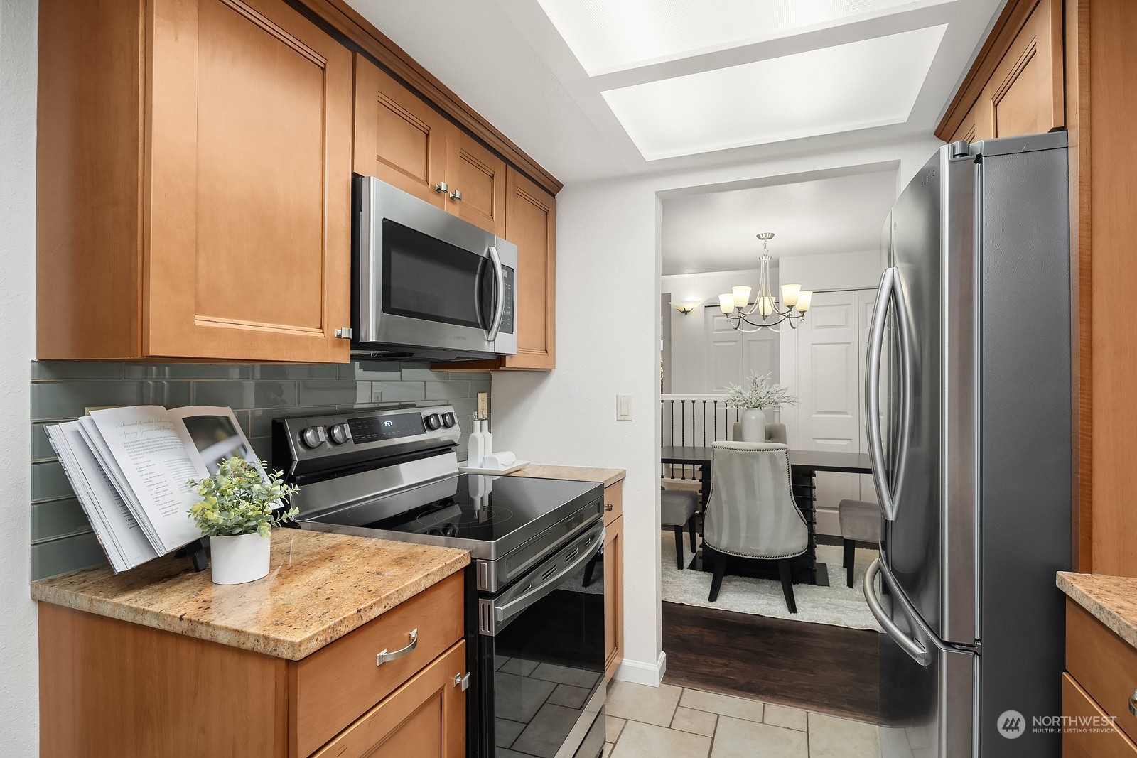 17529 151st Avenue Southeast, Unit 72 Renton, WA 98058 - Photo 9 of 21 a kitchen with a stove a sink and a microwave