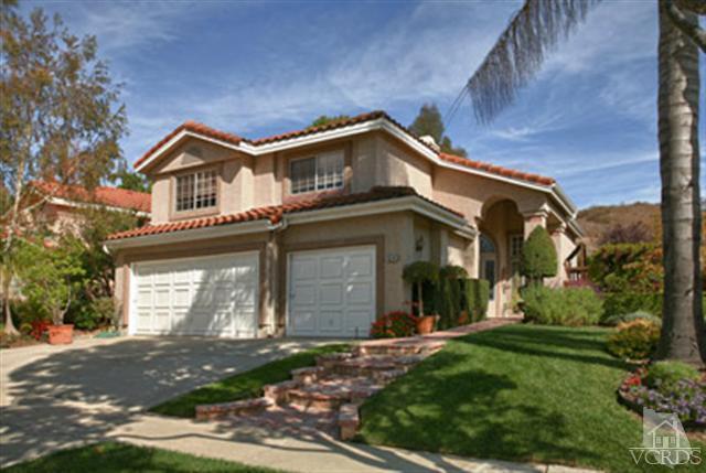 554 Innwood Road Simi Valley, CA 93065 - Photo 1 of 23 a front view of a house with a yard and garage