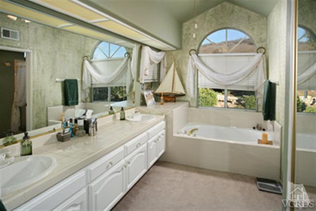 554 Innwood Road Simi Valley, CA 93065 - Photo 13 of 23 a bathroom with a double vanity sink and a mirror