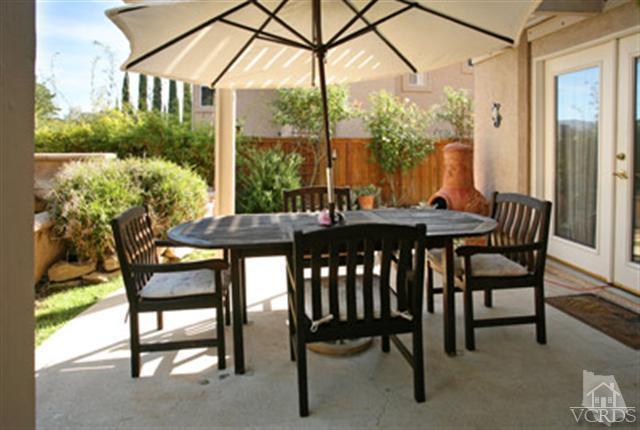 554 Innwood Road Simi Valley, CA 93065 - Photo 20 of 23 a view of an outdoor dining space with furniture and a yard