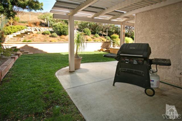 554 Innwood Road Simi Valley, CA 93065 - Photo 22 of 23 a backyard of a house with table and chairs