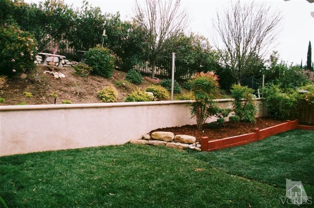 554 Innwood Road Simi Valley, CA 93065 - Photo 23 of 23 a backyard of a house with lots of green space and plants