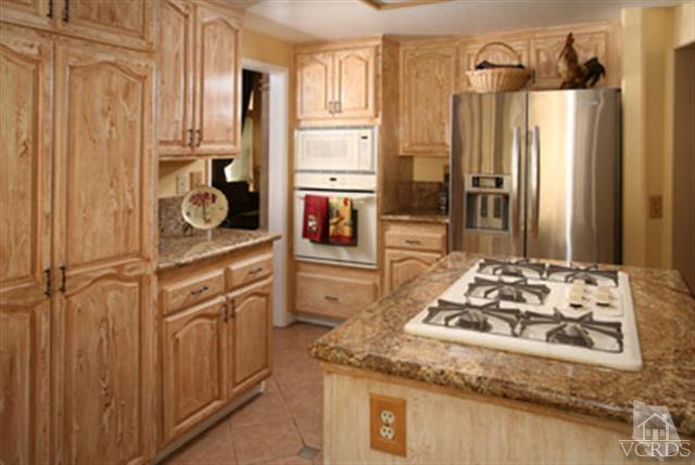 554 Innwood Road Simi Valley, CA 93065 - Photo 9 of 23 a kitchen with stainless steel appliances granite countertop a refrigerator and a stove