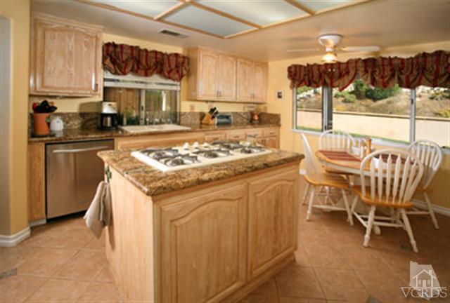 554 Innwood Road Simi Valley, CA 93065 - Photo 10 of 23 a kitchen with a stove a sink and a refrigerator