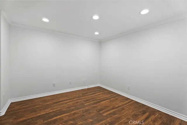 a view of room with wooden floor and fan