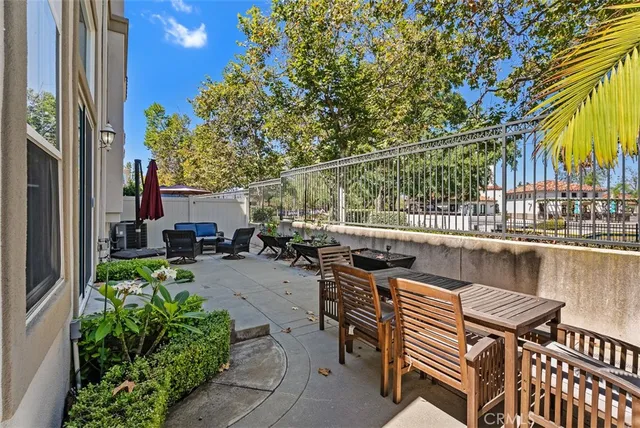 a view of a patio with chairs and potted plants