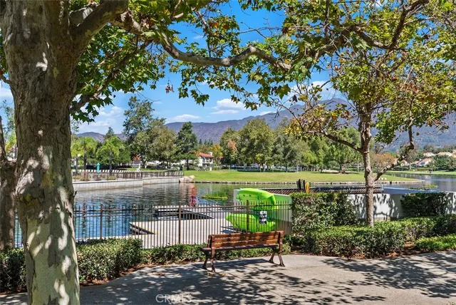 a view of a lake with a bench and trees