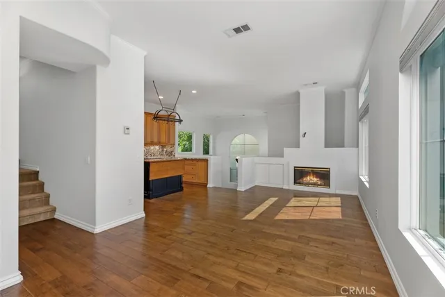 a view of kitchen and hall with wooden floor