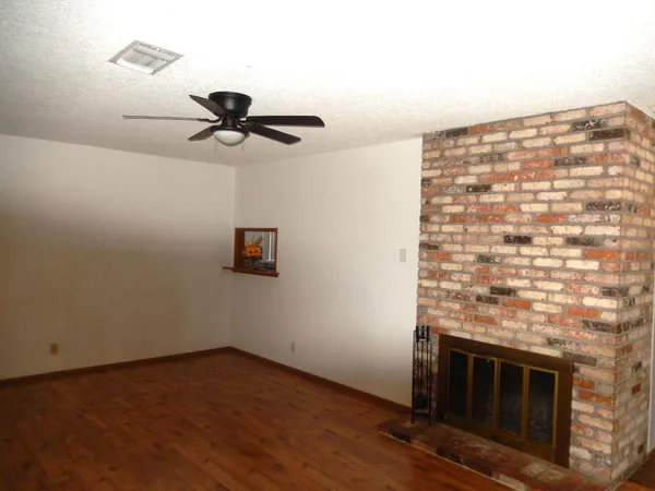 a kitchen with granite countertop a stove a sink and a white cabinets