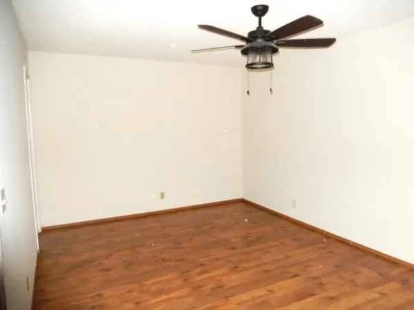 a view of an empty room with a fan