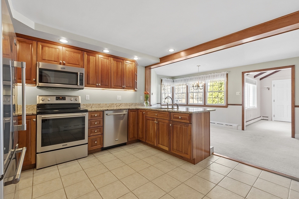 38 Knower Road Westminster, MA 01473 - Photo 4 of 24 a kitchen with stainless steel appliances granite countertop a stove a sink and a microwave