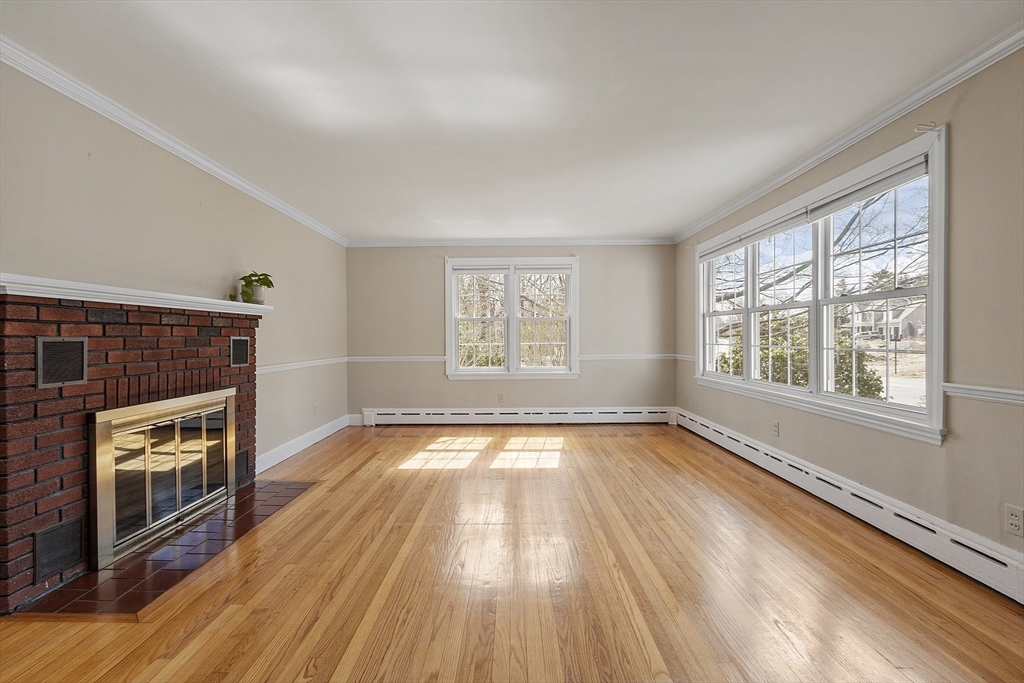 38 Knower Road Westminster, MA 01473 - Photo 8 of 24 an empty room with wooden floor fireplace and windows
