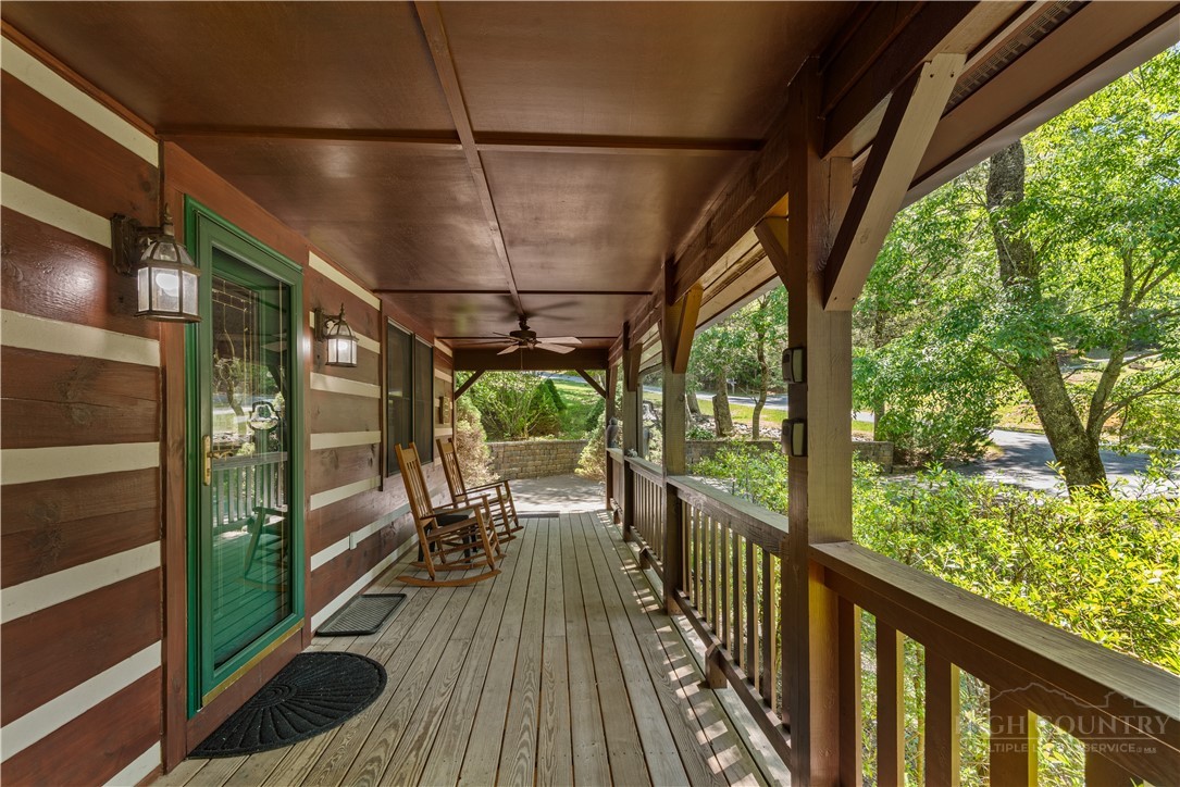 339 Welcome Way Boone, NC 28607 - Photo 19 of 20 a view of a balcony with chairs and wooden floor