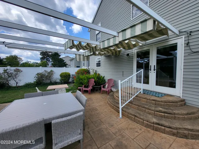 a backyard of a house with outdoor seating