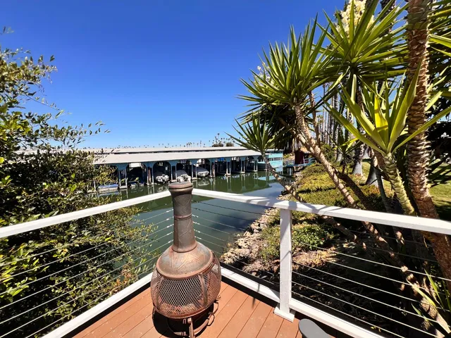 a view of a balcony with two chairs and a table