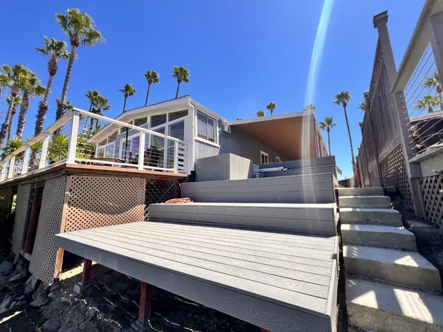 a kitchen with stainless steel appliances kitchen island granite countertop a refrigerator a stove top oven a sink dishwasher and a refrigerator with wooden floor