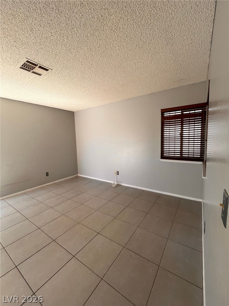 5348 Ravendale Circle Las Vegas, NV 89120 - Photo 6 of 14 A well-maintained living area showcases practical tile flooring and ample natural light through a louvered window.