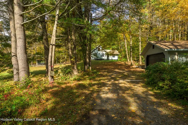 a view of yard with tree and wooden fence