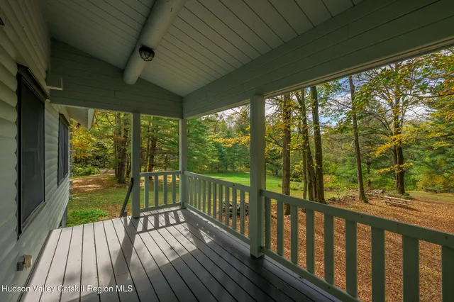 a view of balcony with wooden floor