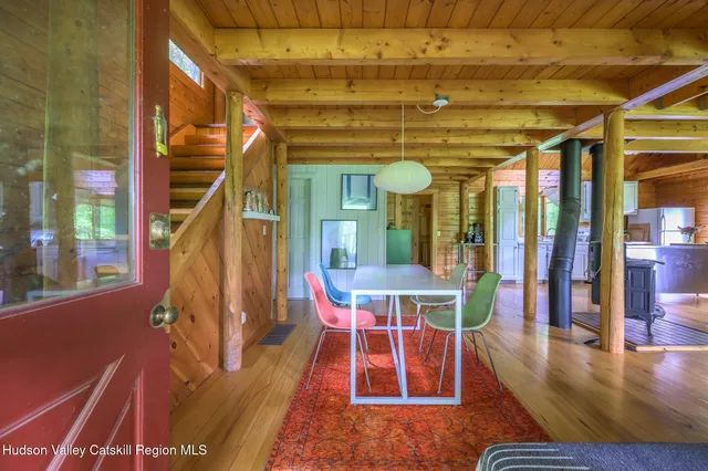 a view of a dining room with wooden floor and windows