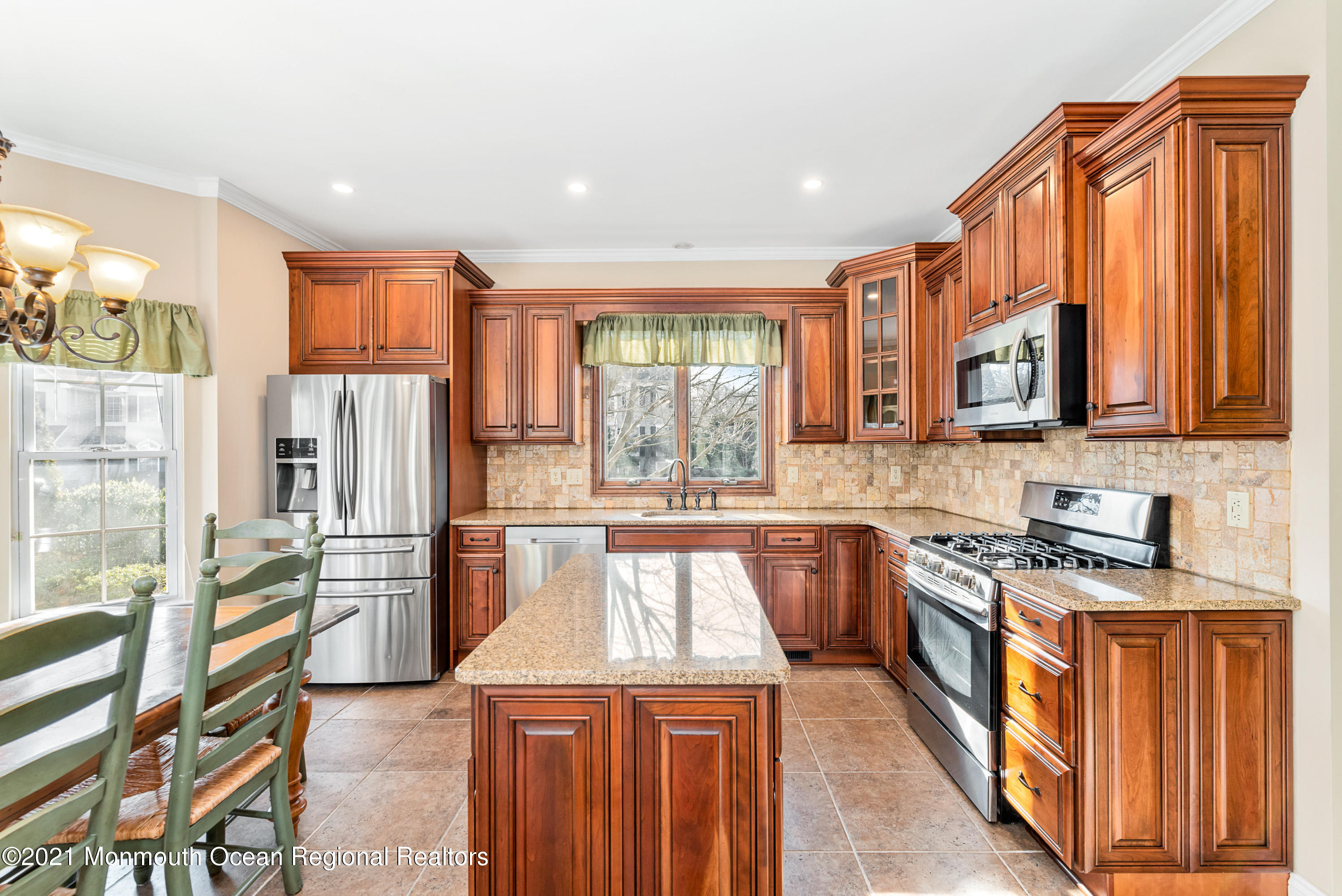 11 Grindstone Road Howell, NJ 07731 - Photo 13 of 45 a kitchen with stainless steel appliances granite countertop a stove a sink dishwasher a refrigerator and wooden cabinets with wooden floor