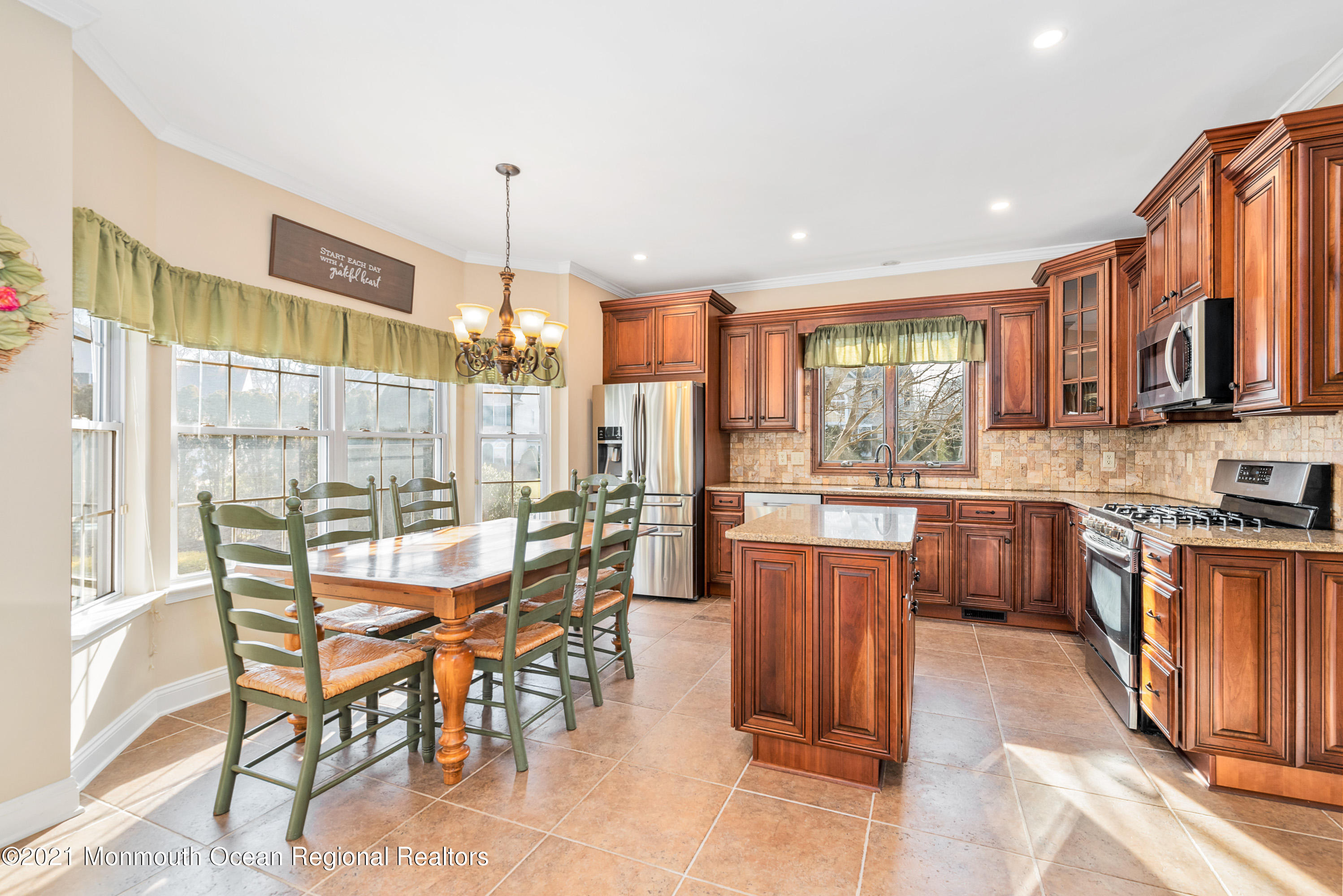 11 Grindstone Road Howell, NJ 07731 - Photo 15 of 45 a dining hall with stainless steel appliances granite countertop a stove and a dining table chair