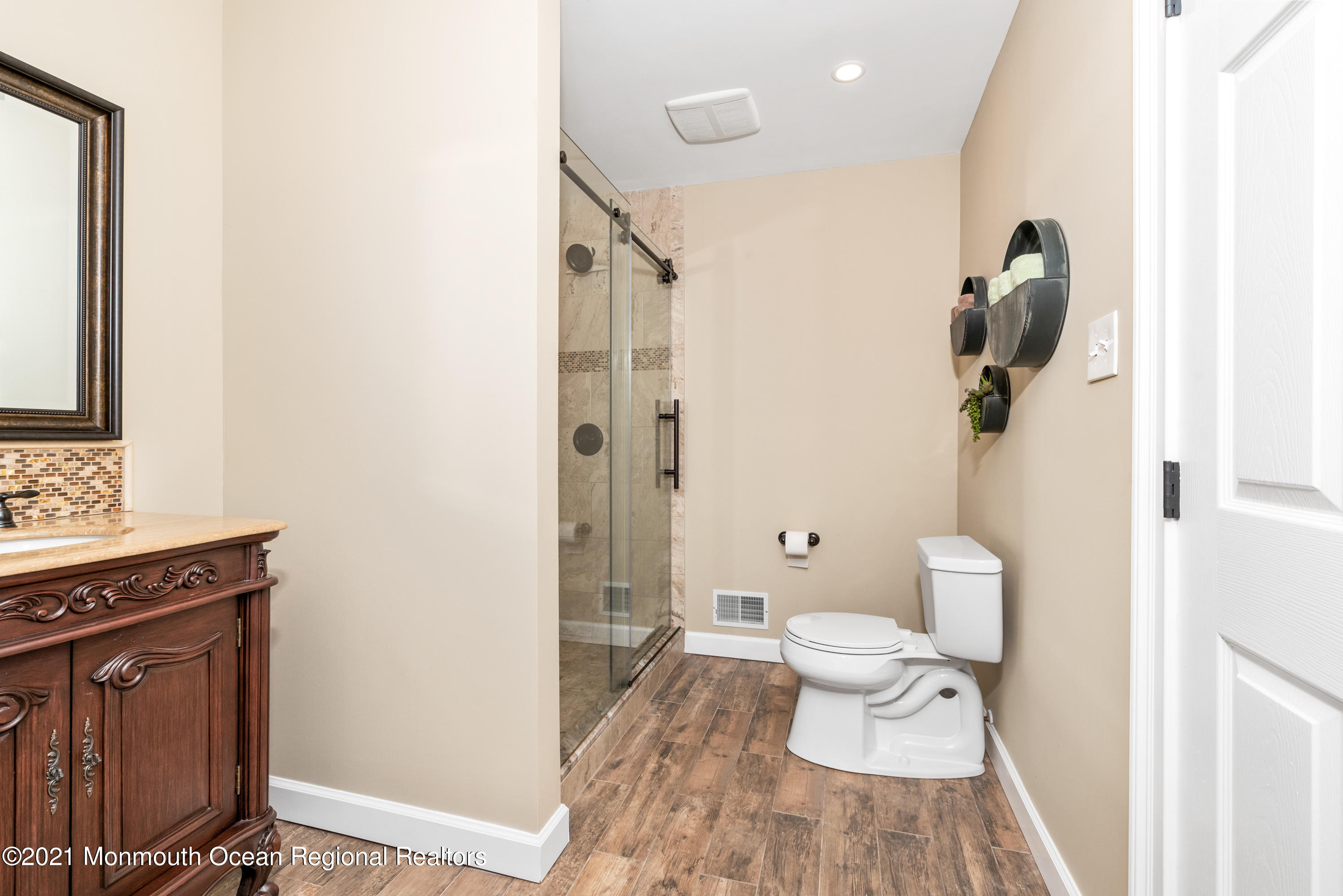11 Grindstone Road Howell, NJ 07731 - Photo 26 of 45 a bathroom with a toilet a sink and mirror