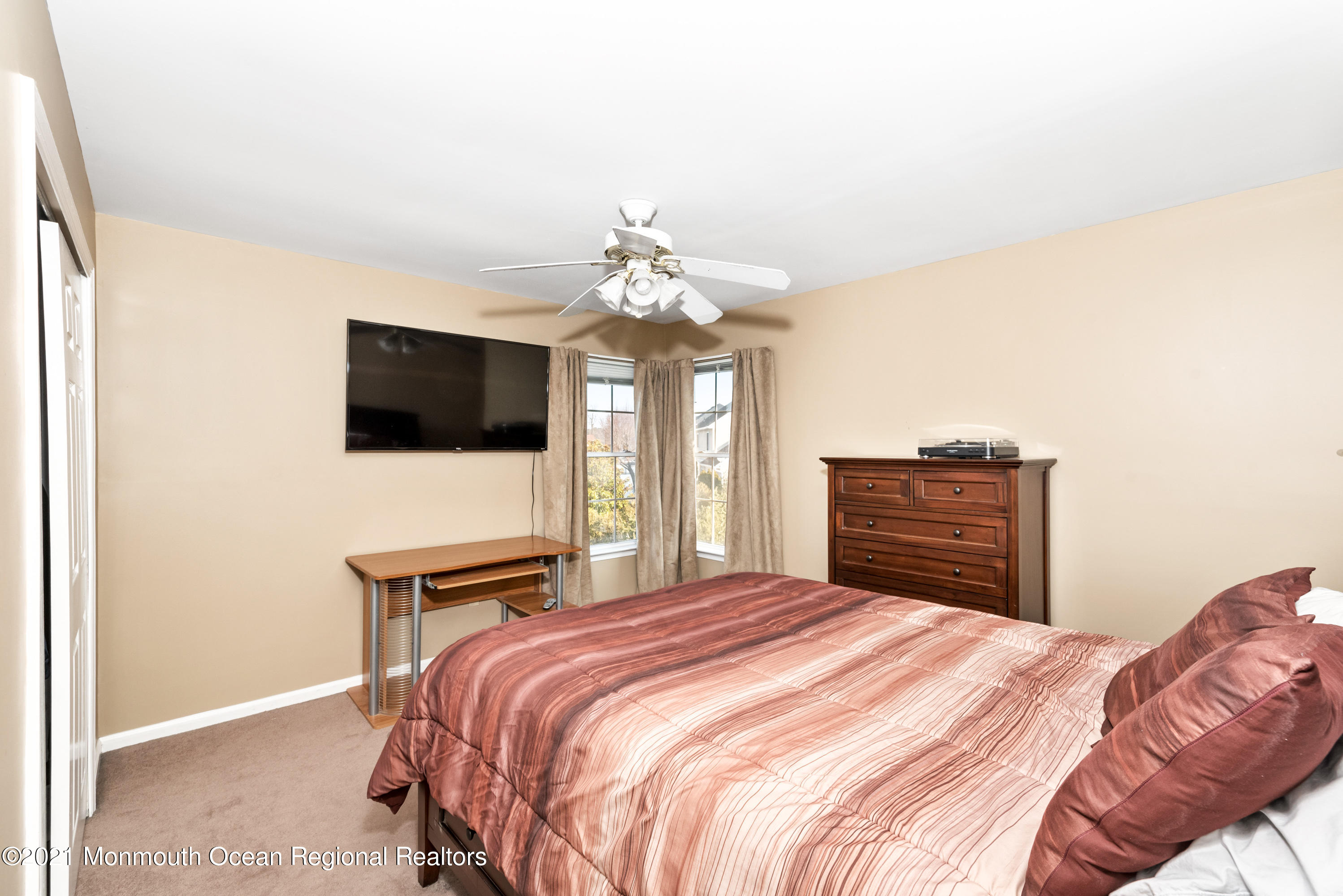 11 Grindstone Road Howell, NJ 07731 - Photo 33 of 45 a bedroom with a bed and a flat screen tv