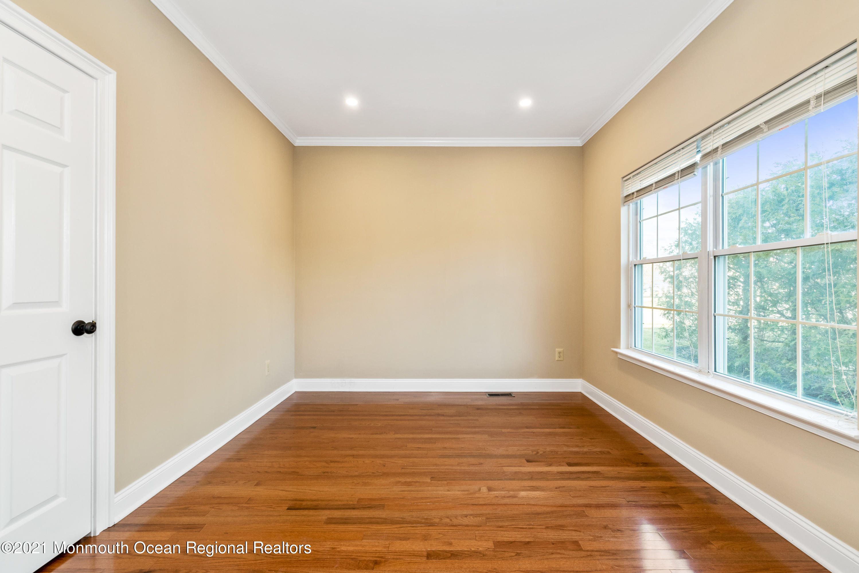 11 Grindstone Road Howell, NJ 07731 - Photo 34 of 45 a view of empty room with wooden floor and fan