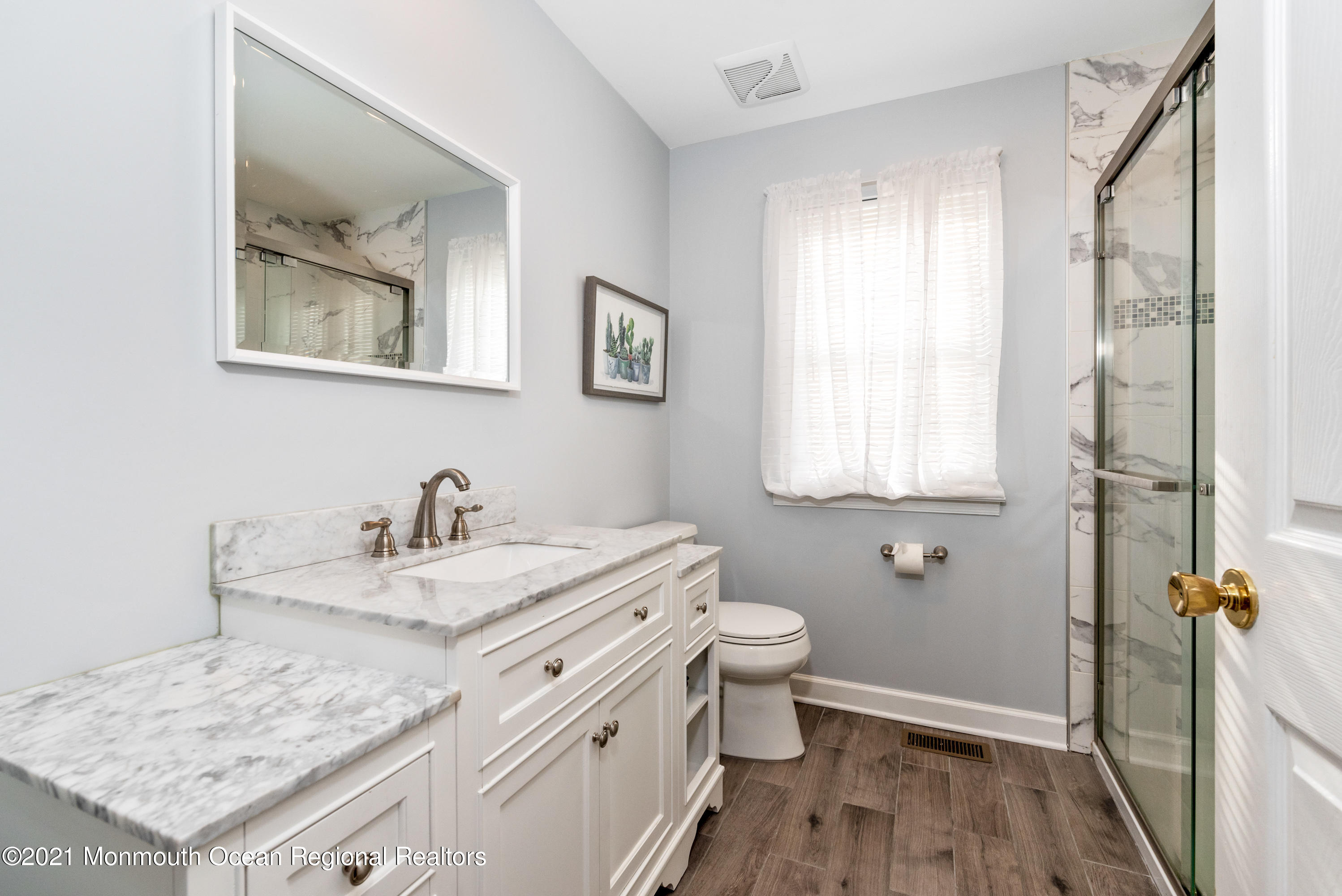 11 Grindstone Road Howell, NJ 07731 - Photo 35 of 45 a bathroom with a granite countertop sink toilet and painting on the wall