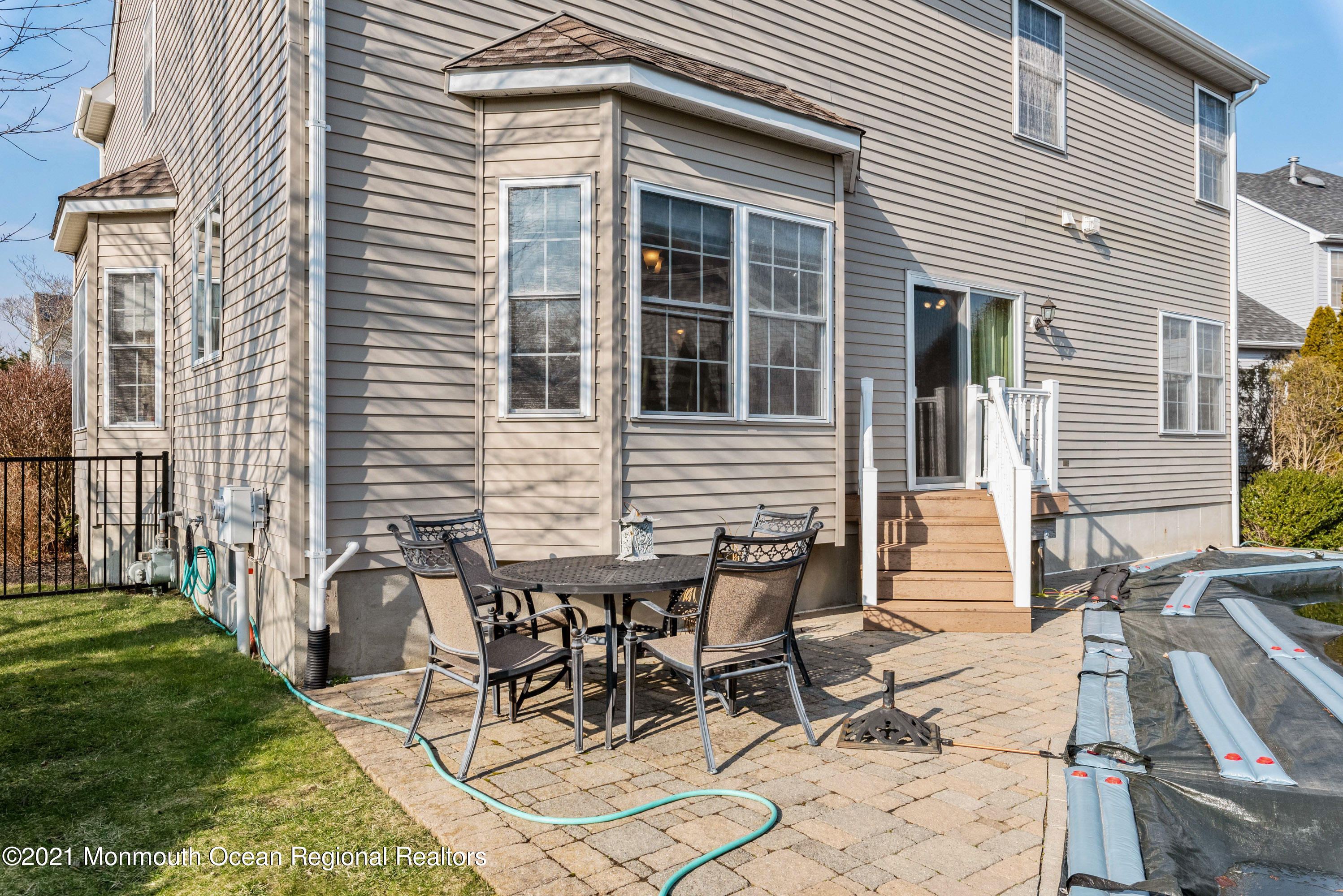 11 Grindstone Road Howell, NJ 07731 - Photo 40 of 45 a view of a backyard with table and chairs and a barbeque