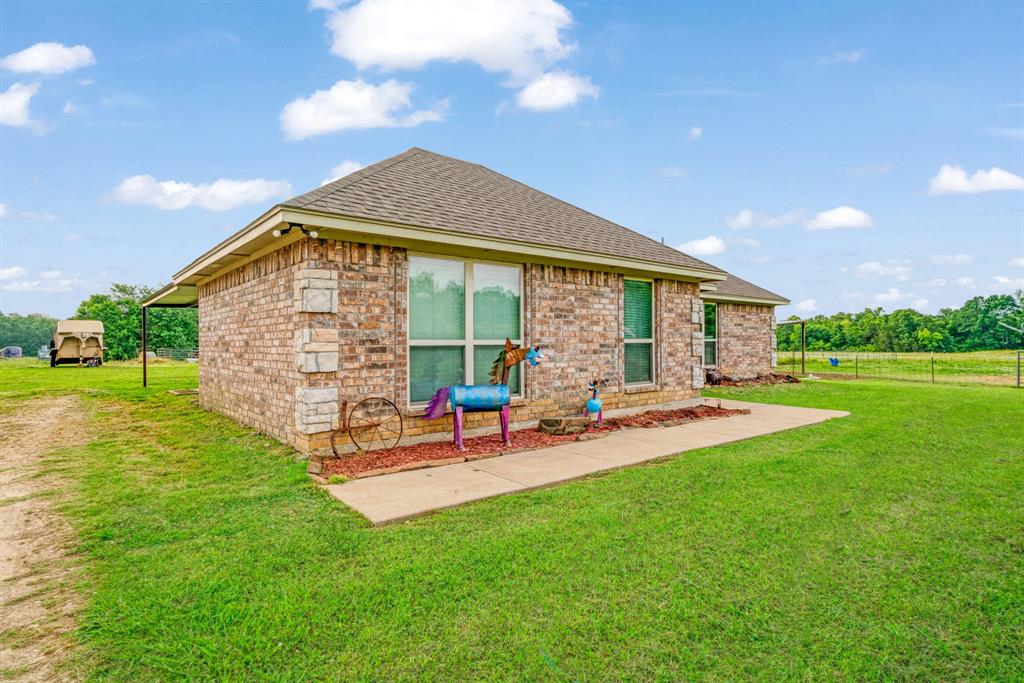 1890 County Road Sumner, TX 75486 - Photo 2 of 20 a view of a house with backyard porch and sitting area