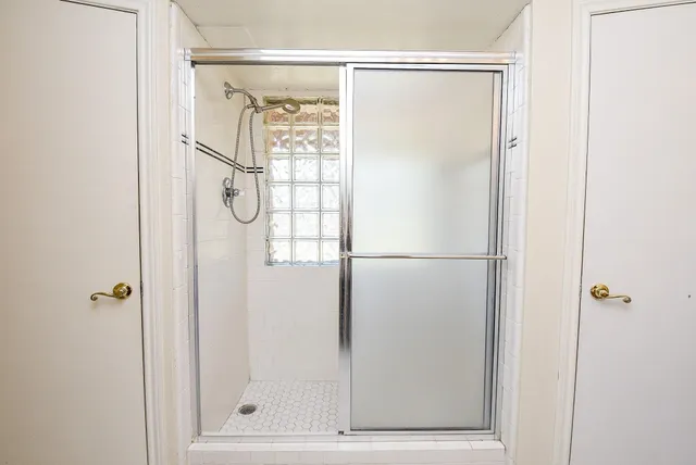a bathroom with a double vanity sink a mirror and a bathtub