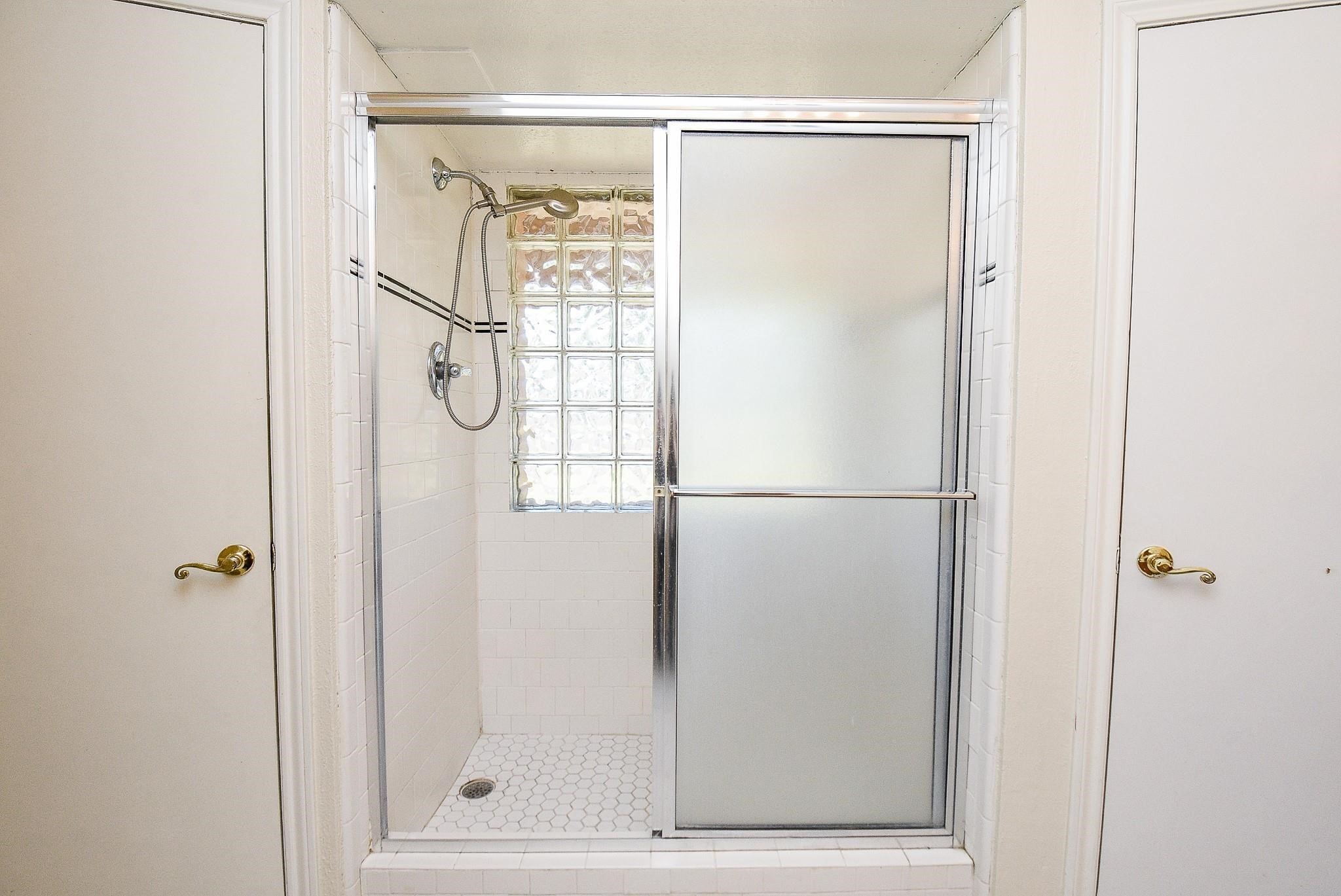 2623 Forestbrook Drive Spring, TX 77373 - Photo 12 of 27 a bathroom with a glass shower door