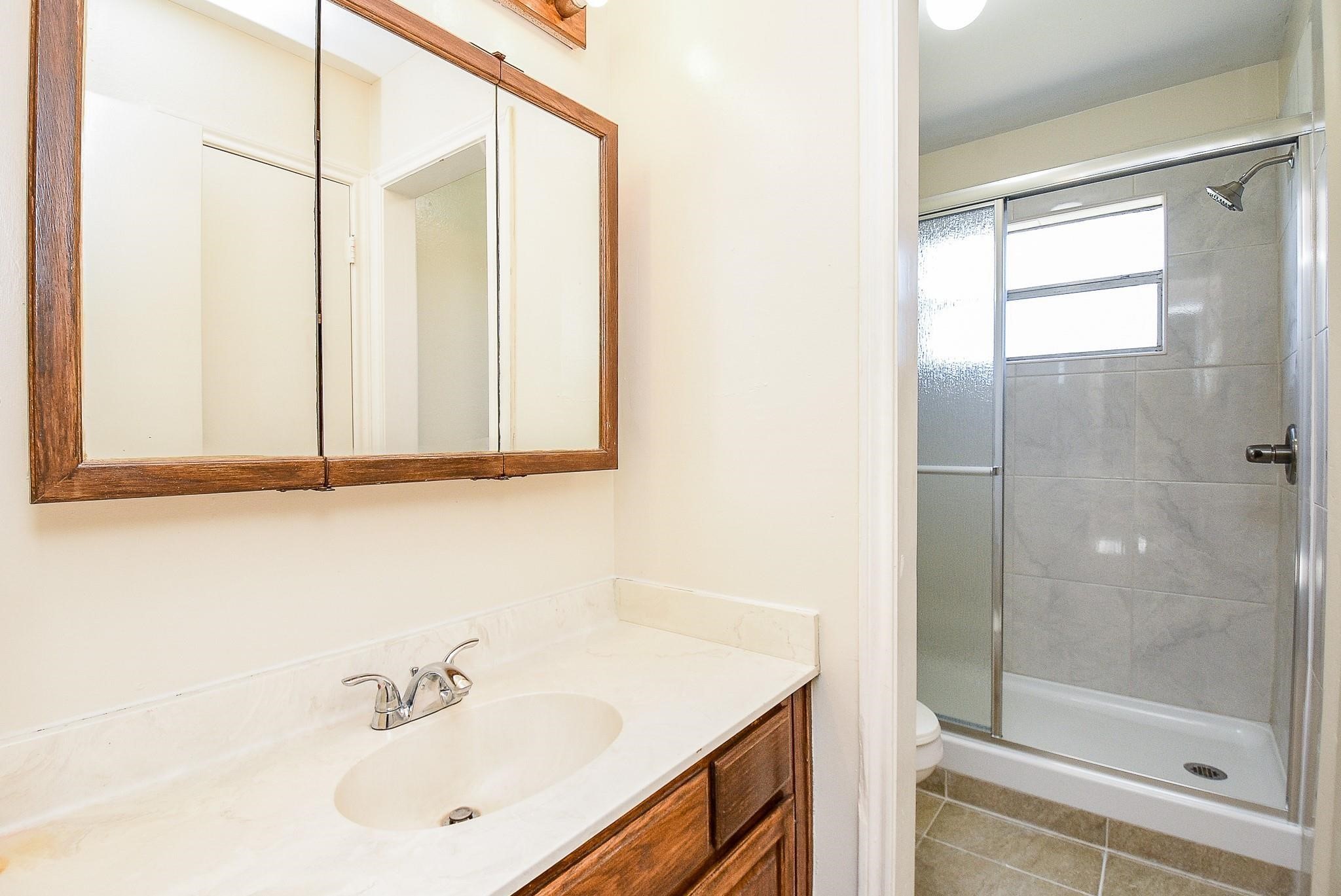 2623 Forestbrook Drive Spring, TX 77373 - Photo 16 of 27 a bathroom with a sink and a shower