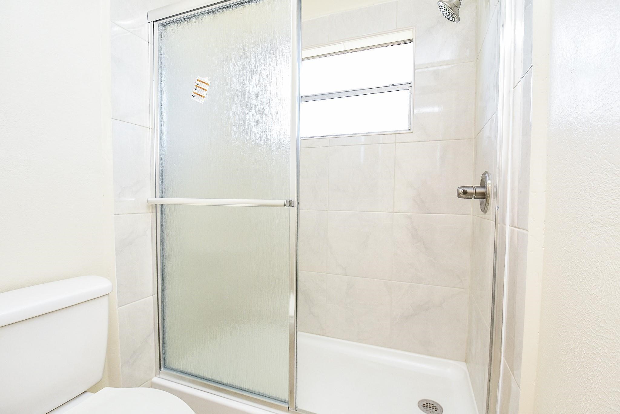 2623 Forestbrook Drive Spring, TX 77373 - Photo 17 of 27 a bathroom with a shower and a toilet