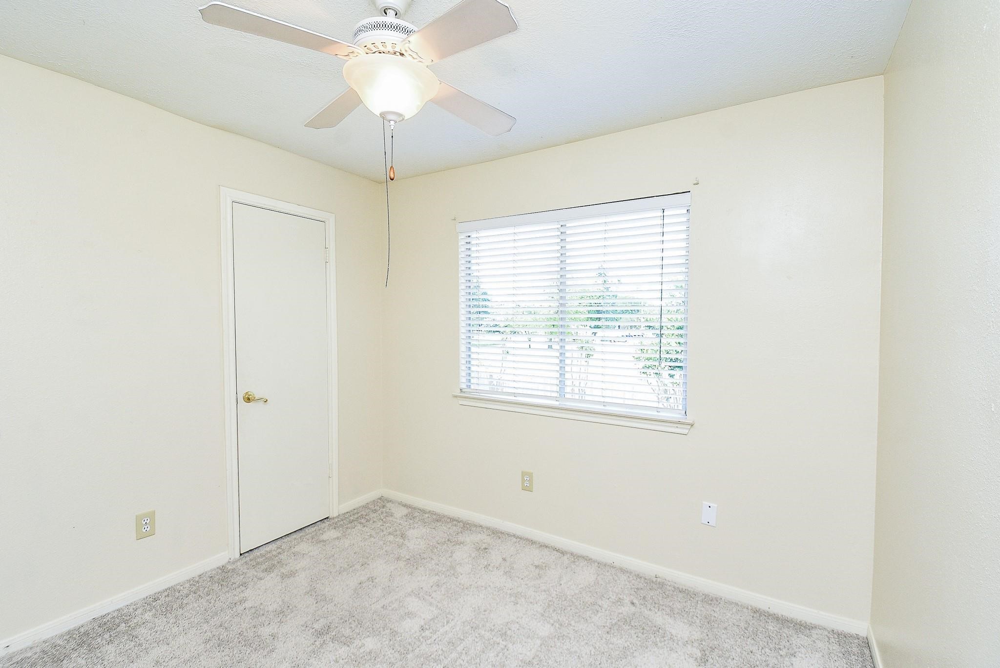 2623 Forestbrook Drive Spring, TX 77373 - Photo 20 of 27 an empty room with a window and a chandelier fan