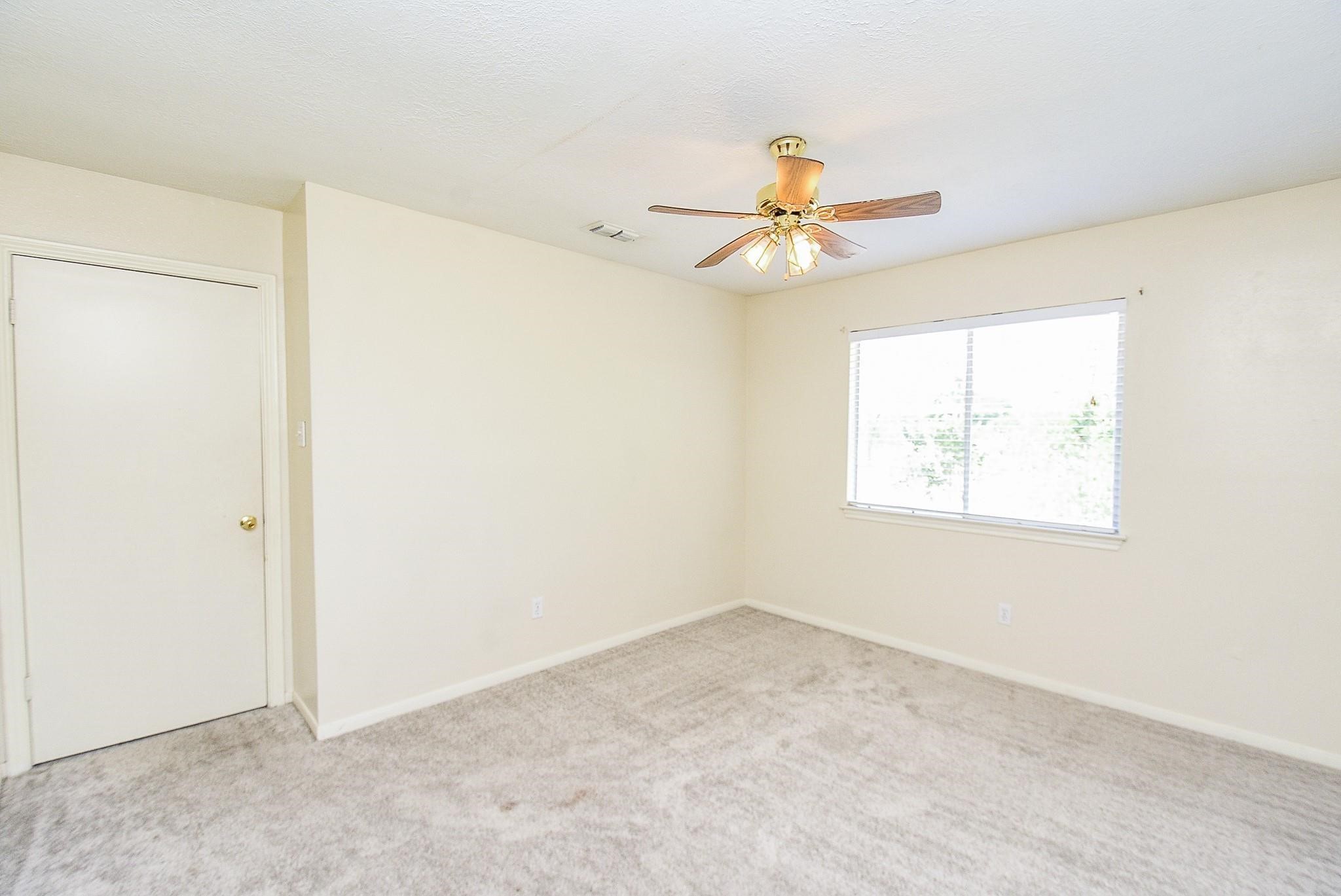 2623 Forestbrook Drive Spring, TX 77373 - Photo 21 of 27 an empty room with a window and a fan