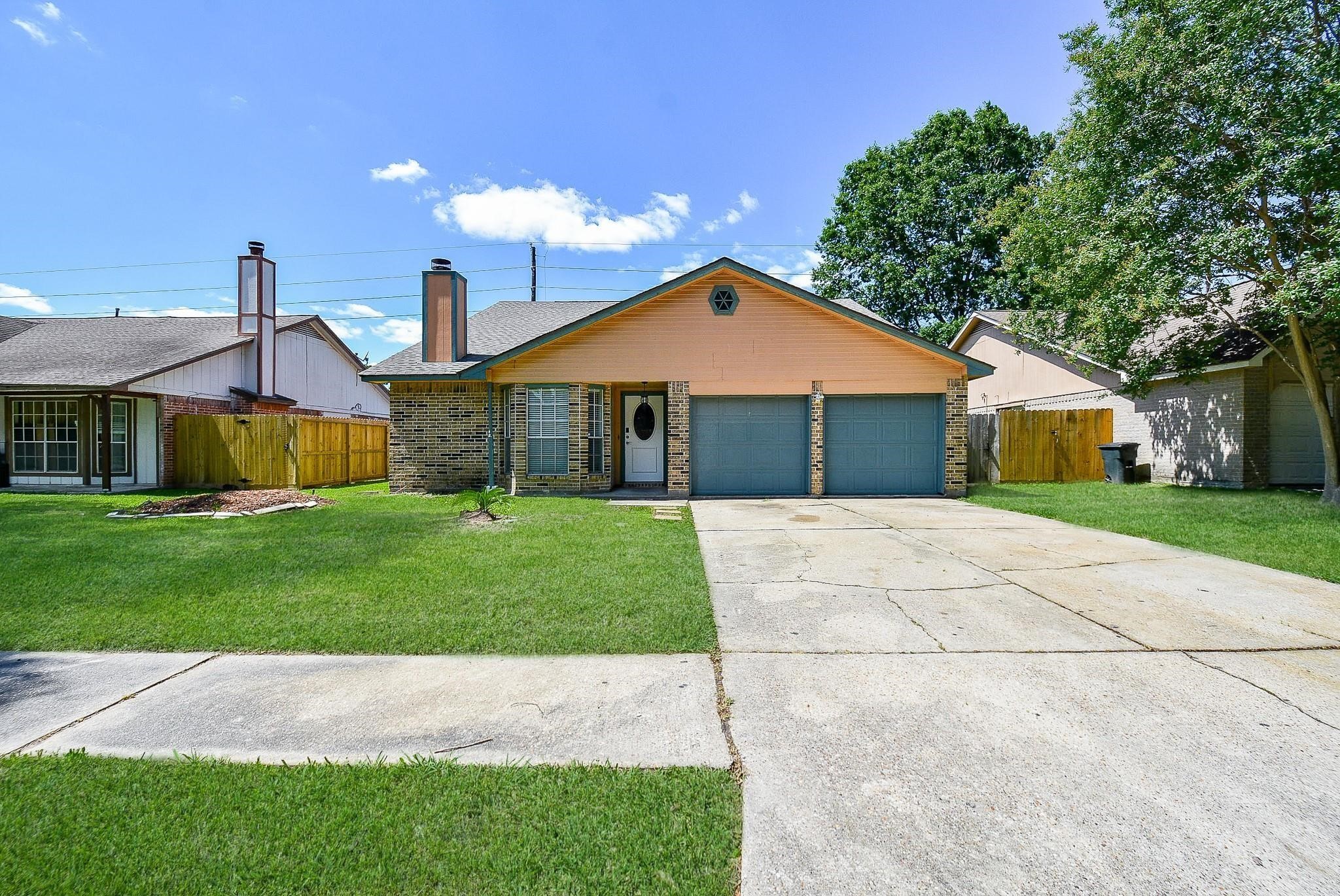 2623 Forestbrook Drive Spring, TX 77373 - Photo 3 of 27 a front view of a house with a garden and yard